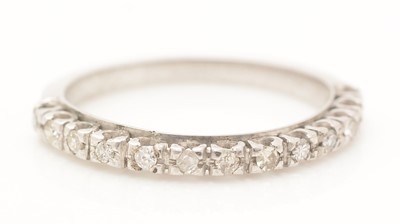 Lot 394 - A diamond half hoop eternity ring