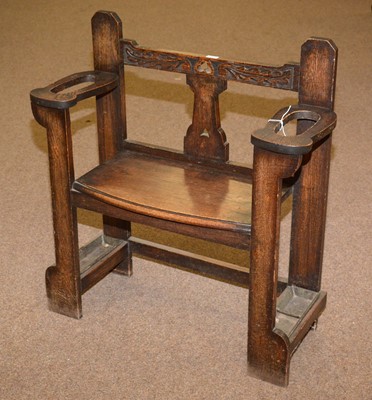 Lot 39 - An early 20th Century carved oak hall seat/stick stand.
