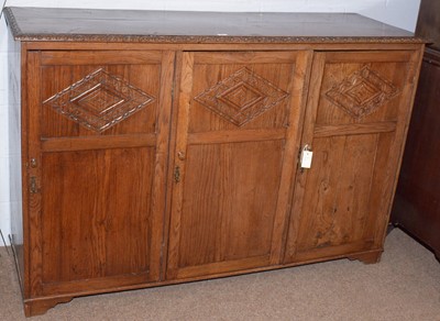 Lot 60 - A carved oak cupboard.