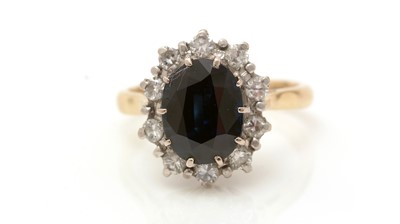 Lot 415 - A sapphire and diamond cluster ring