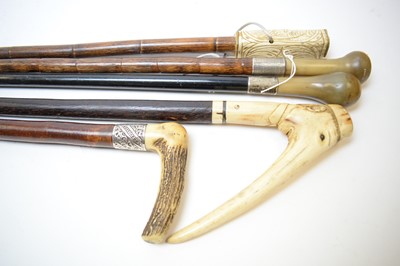 Lot 397 - Two silver collared horn handled walking sticks and three others.