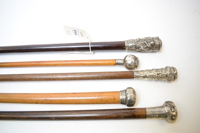 Lot 215 - A silver capped swagger stick and four walking sticks.