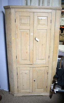 Lot 51 - A 19th Century stripped pine floor standing corner cupboard.