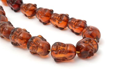 Lot 668 - Amber Buddha head bead necklace