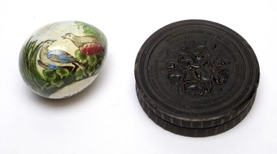 Lot 144 - An early 19th century pressed horn circular snuff box and a darning egg