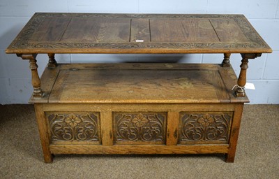 Lot 9 - An early 20th Century carved oak monk's bench.