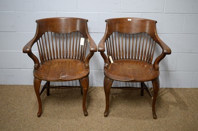 Lot 19 - A pair of early 20th Century oak bow-back smokers chairs.