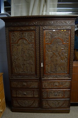 Lot 66 - A profusely carved oak wardrobe, basically Georgian with later Victorian carving.