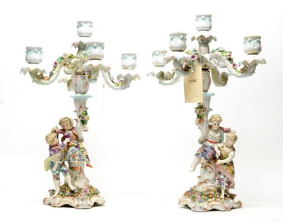 Lot 392 - A pair of German candelabra.