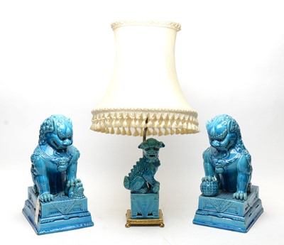 Lot 233 - A pair of Chinese Buddhist lion figures and a lamp