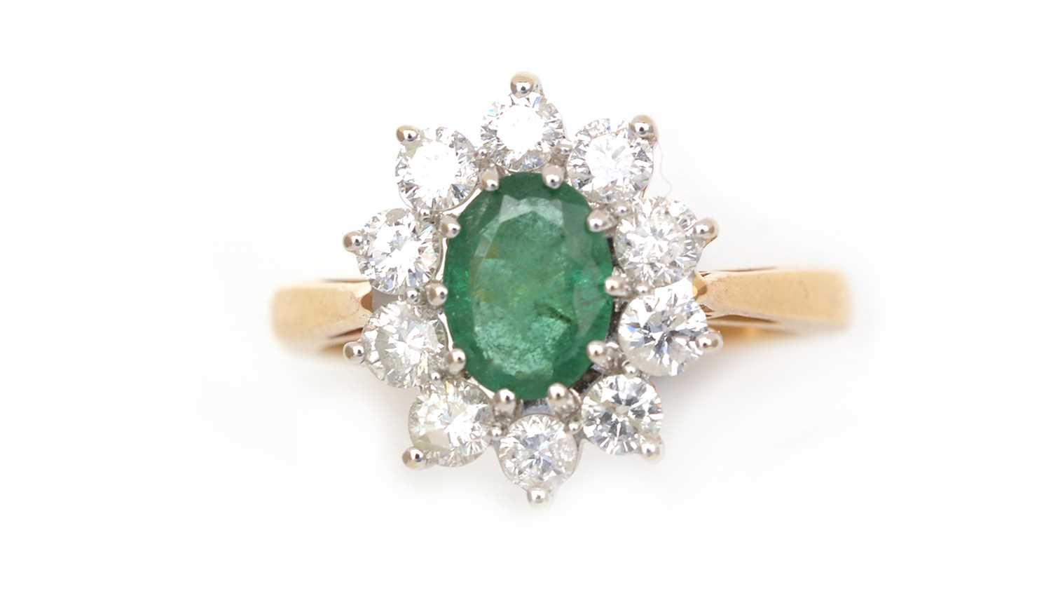 Lot 345 - An emerald and diamond cluster ring