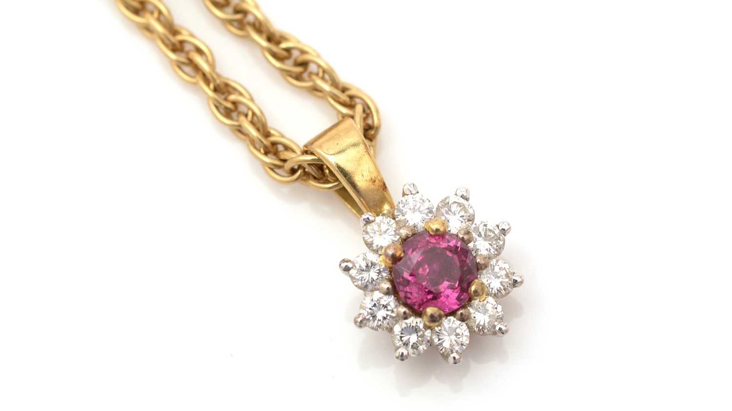 Lot 334 - A ruby and diamond cluster pendant