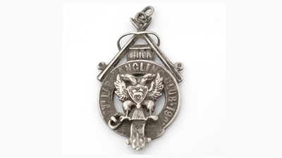 Lot 390 - An Edwardian Scottish provincial silver fob badge.