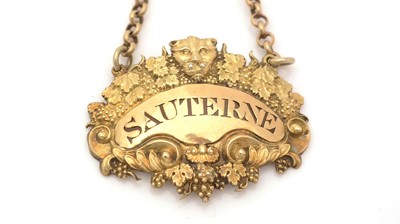 Lot 240 - A late George III silver-gilt wine label.