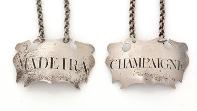 Lot 281 - A pair of George III silver escutcheon wine labels.