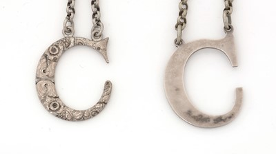 Lot 245 - Two Victorian silver cut-out letter "C" wine labels.