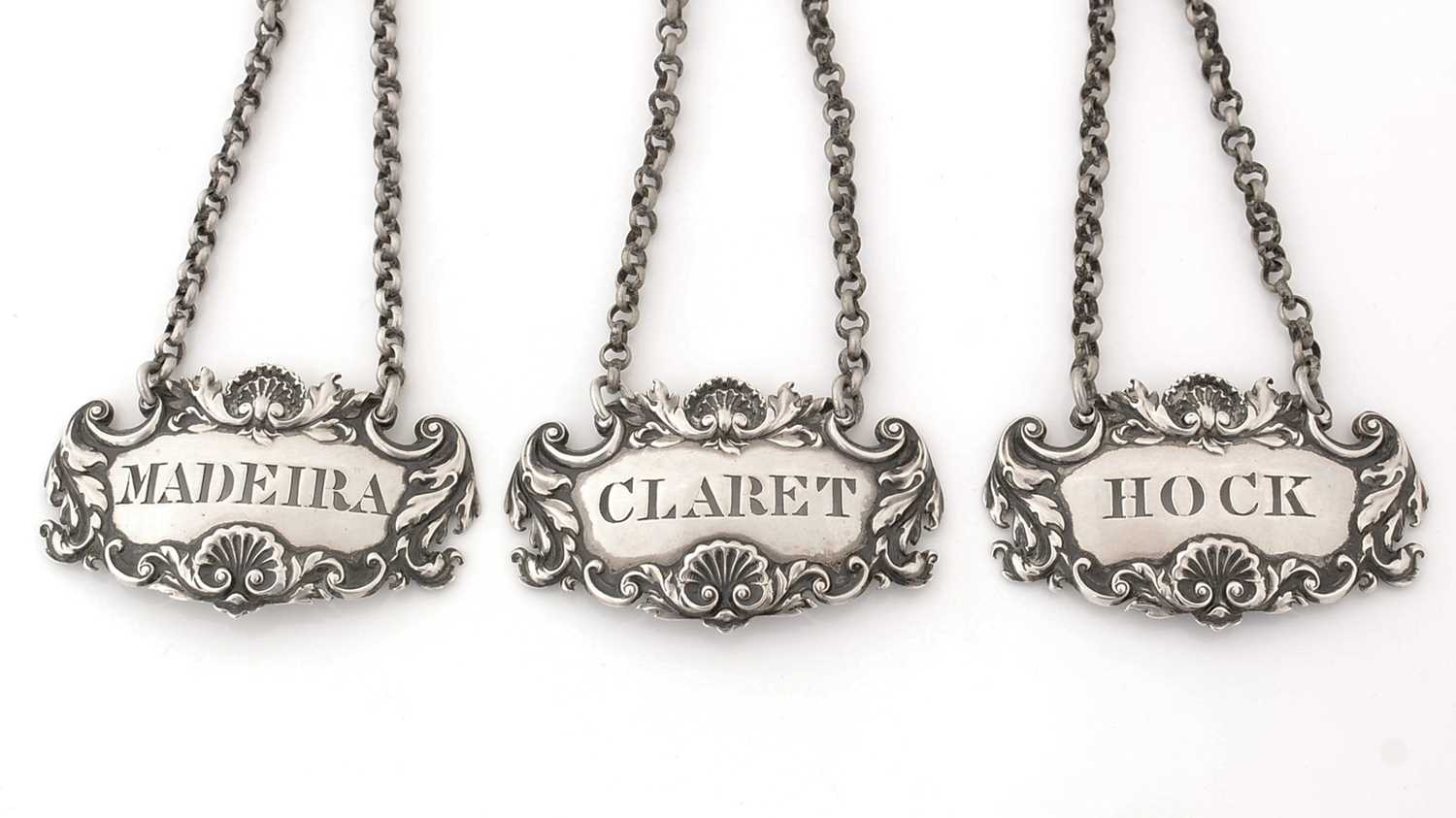 Lot 228 - A set of three William IV silver wine labels.