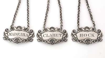 Lot 228 - A set of three William IV silver wine labels.