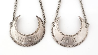 Lot 252 - A pair of George III silver wine labels.
