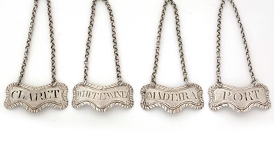 Lot 261 - A set of four early George III silver wine labels.