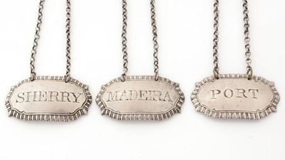 Lot 285 - A set of three George III silver wine labels.