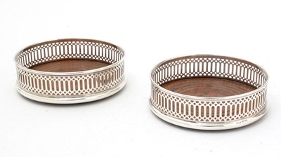 Lot 157 - A pair of Elizabeth II silver-mounted wine coasters.