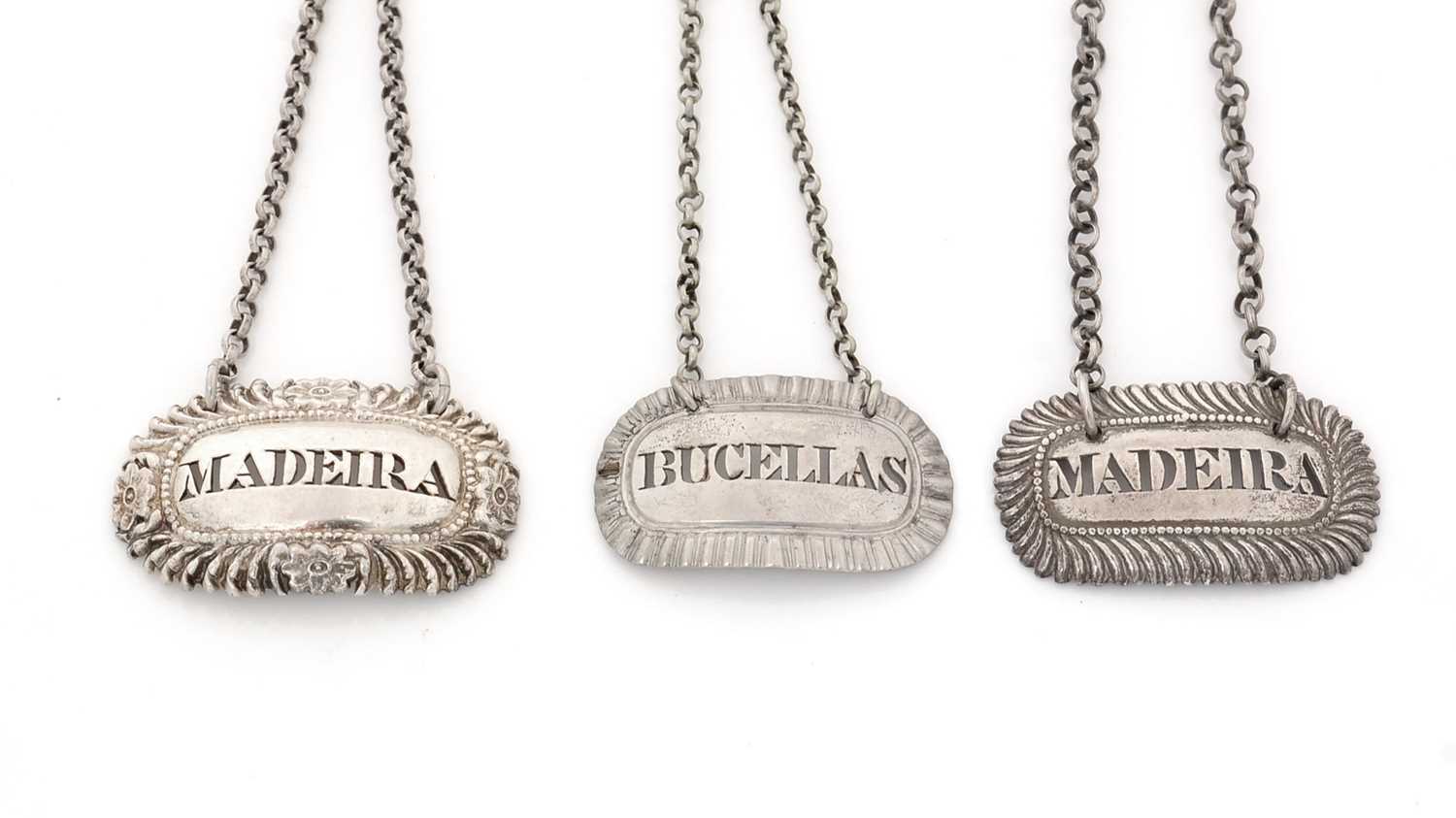 Lot 232 - Three George IV silver wine labels, various.