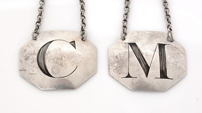 Lot 234 - A pair of George III silver wine labels.