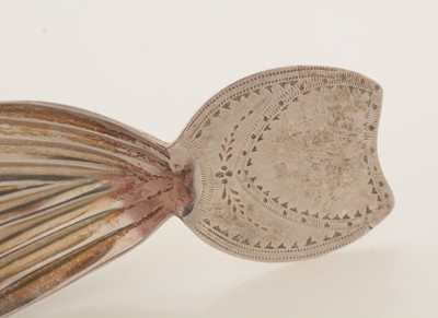 Lot 63 - A George III silver caddy spoon; and another caddy spoon.