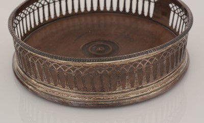 Lot 195 - Two similar George III silver-mounted wine coasters.