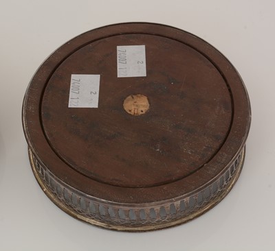 Lot 195 - Two similar George III silver-mounted wine coasters.