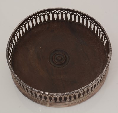 Lot 195 - Two similar George III silver-mounted wine coasters.