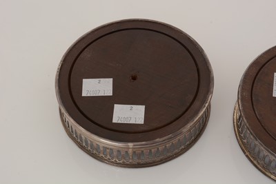 Lot 195 - Two similar George III silver-mounted wine coasters.