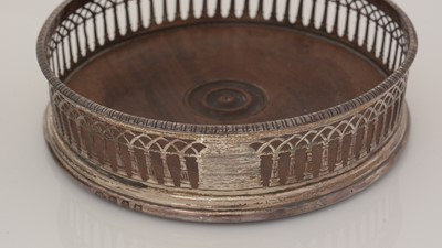 Lot 195 - Two similar George III silver-mounted wine coasters.