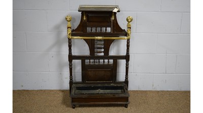 Lot 14 - Manner of James Shoolbred & Co: a late Victorian oak and brass stick stand.