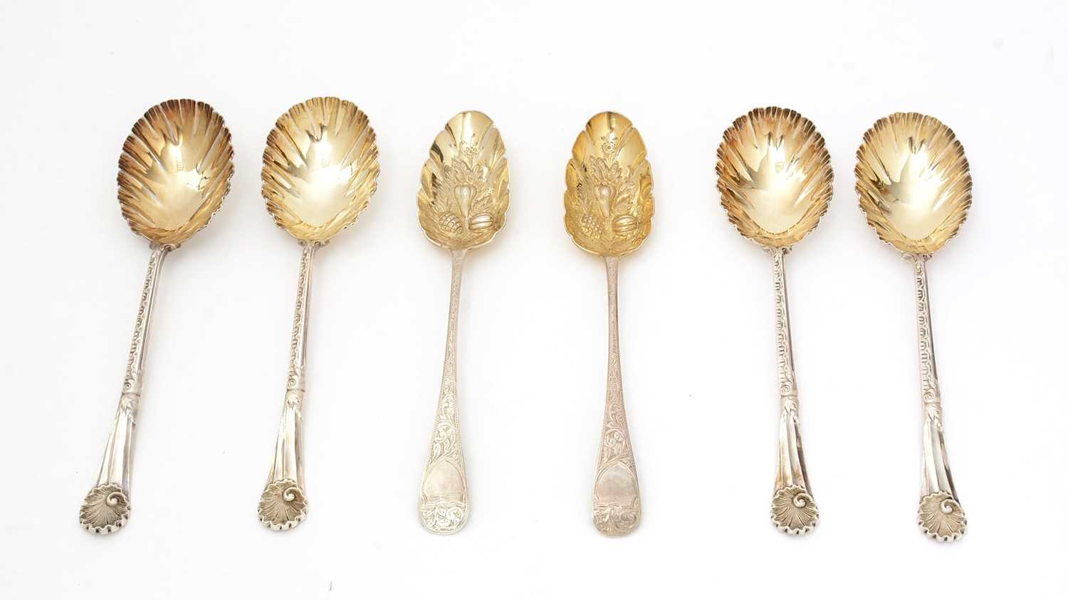 Lot 7 - A set of four late Victorian silver fruit serving spoons; and a pair of silver berry tablespoons.