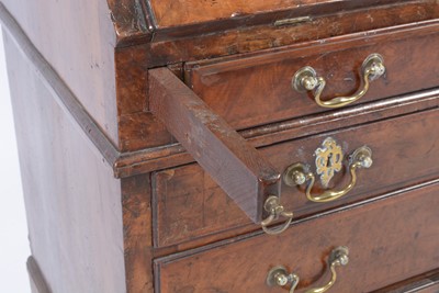Lot 1115 - A Queen Anne walnut bureau bookcase.