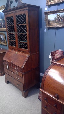 Lot 1115 - A Queen Anne walnut bureau bookcase.