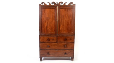 Lot 1125 - An early 19th century mahogany linen press