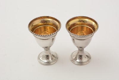 Lot 162 - A George III silver egg frame, four later egg spoons and four plated egg cups.