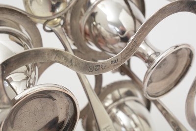 Lot 162 - A George III silver egg frame, four later egg spoons and four plated egg cups.