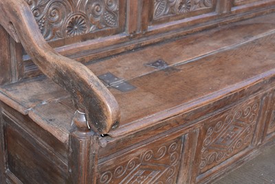 Lot 1104 - A North Country joined and carved oak box settle.