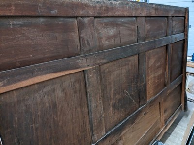 Lot 1104 - A North Country joined and carved oak box settle.
