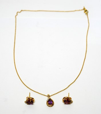 Lot 103 - An amethyst and diamond pendant and matching earrings