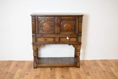 Lot 35 - Manner of Titchmarsh & Goodwin: a Jacobean Revival oak cabinet on stand / buffet