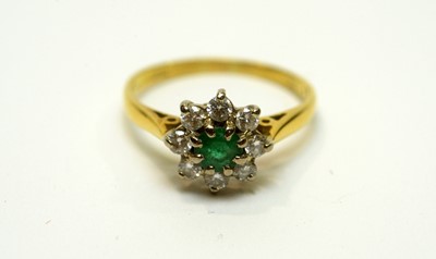 Lot 180 - An emerald and diamond cluster ring