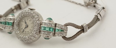 Lot 606 - An Art Deco emerald and diamond cocktail watch