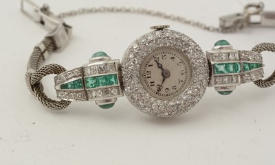 Lot 606 - An Art Deco emerald and diamond cocktail watch