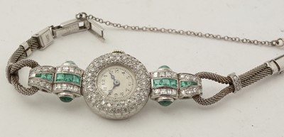 Lot 606 - An Art Deco emerald and diamond cocktail watch