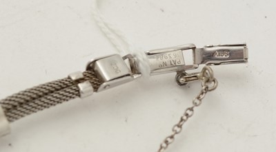 Lot 606 - An Art Deco emerald and diamond cocktail watch